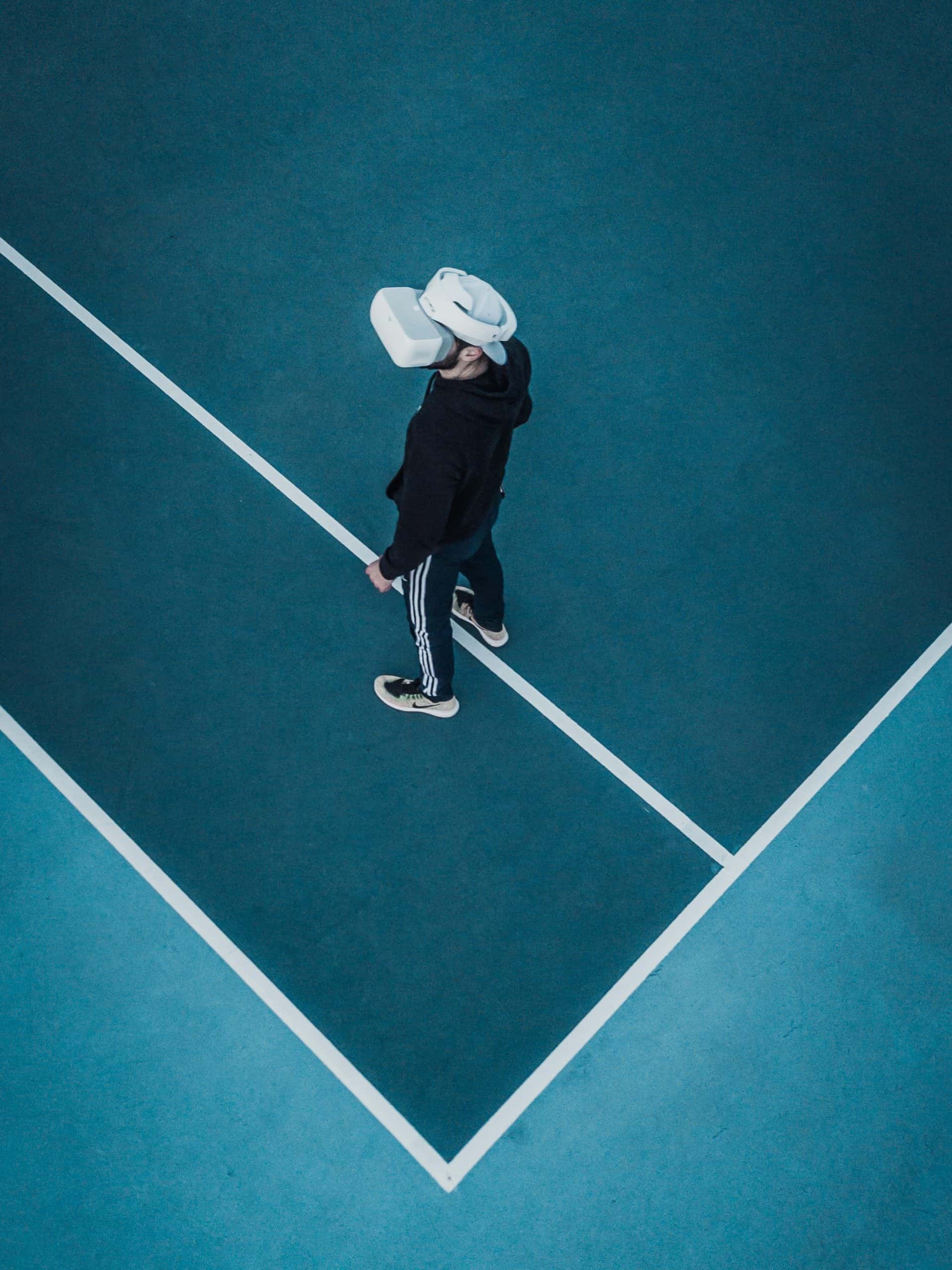 Image of someone wearing a virtual reality headset on a tennis court