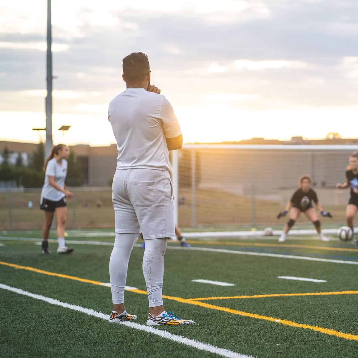 image of soccer coach watching his team